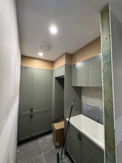 Custom joinery framing for the newly decoupled laundry suite.