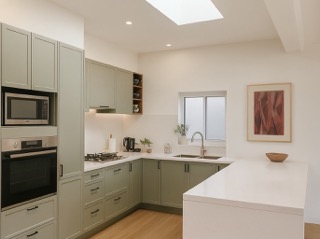Custom U-shaped kitchen with entertainer's island and integrated appliances.