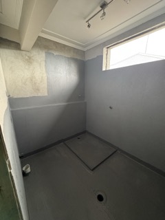 Rigorous Class III wet area waterproofing membrane application and detailing.