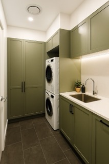 Dedicated laundry suite with floor-to-ceiling concealed linen and utility storage.