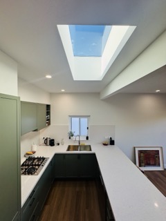 Operable external double-brick window bringing natural breeze directly over the sink.