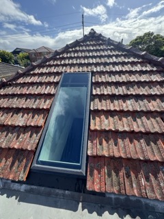 Architectural skylight pouring direct vertical sunlight into the core of the home.