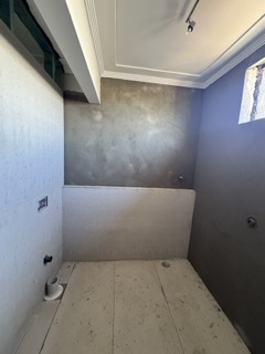 Acoustic wall and floor lining installation with precision square-set joints.