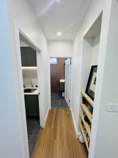 Clean architectural sightlines connecting living zones with acoustic hybrid flooring.