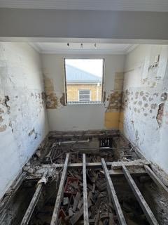 Original subfloor structure showing wear and floor movement.