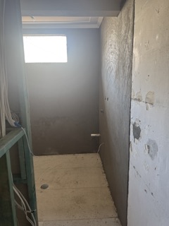 Substrate rendering and surface prep for wet area tiling.