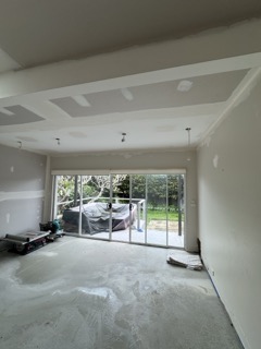 Comprehensive self-leveling compound application creating a true, flat floor plane.